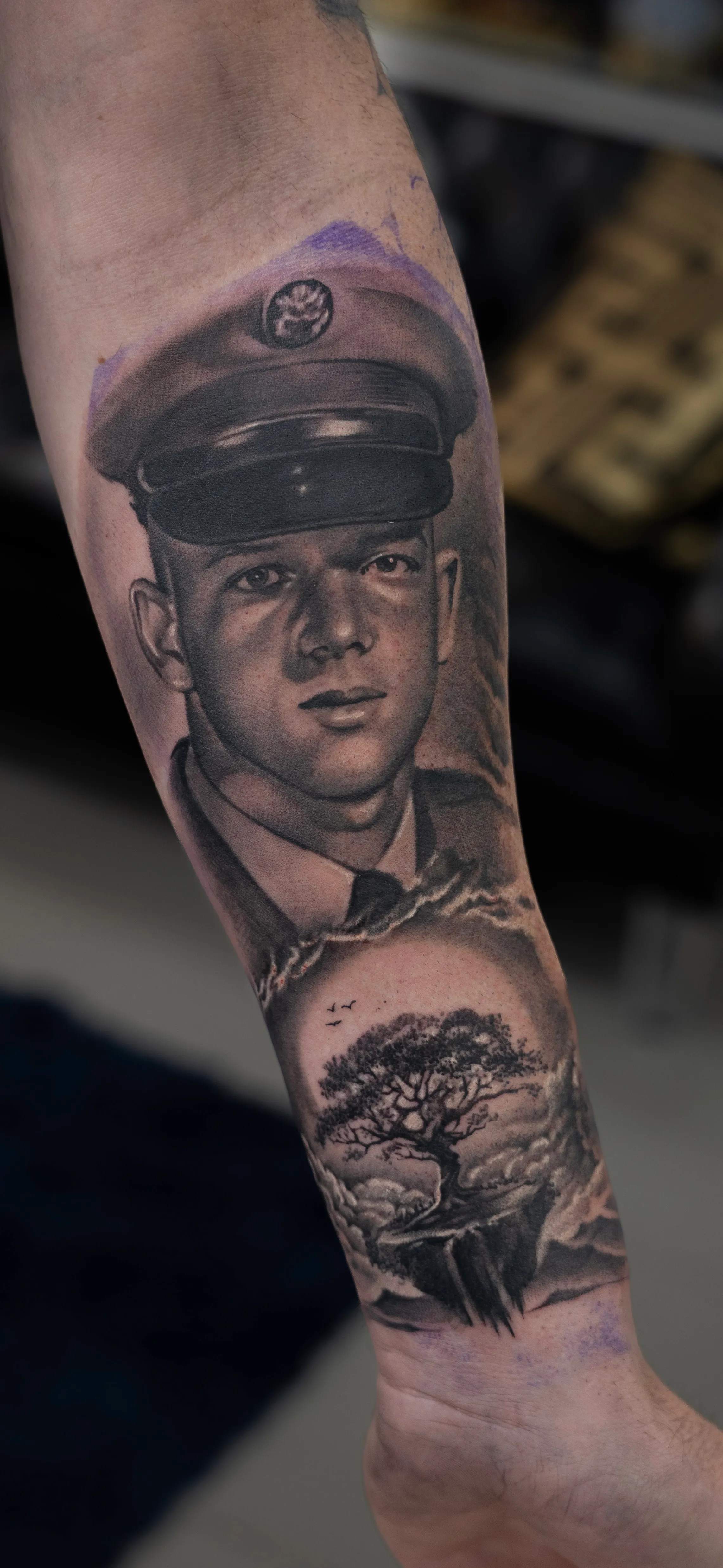 Black-and-grey memorial portrait of a young serviceman in uniform above an oak tree — TKOTATTOO